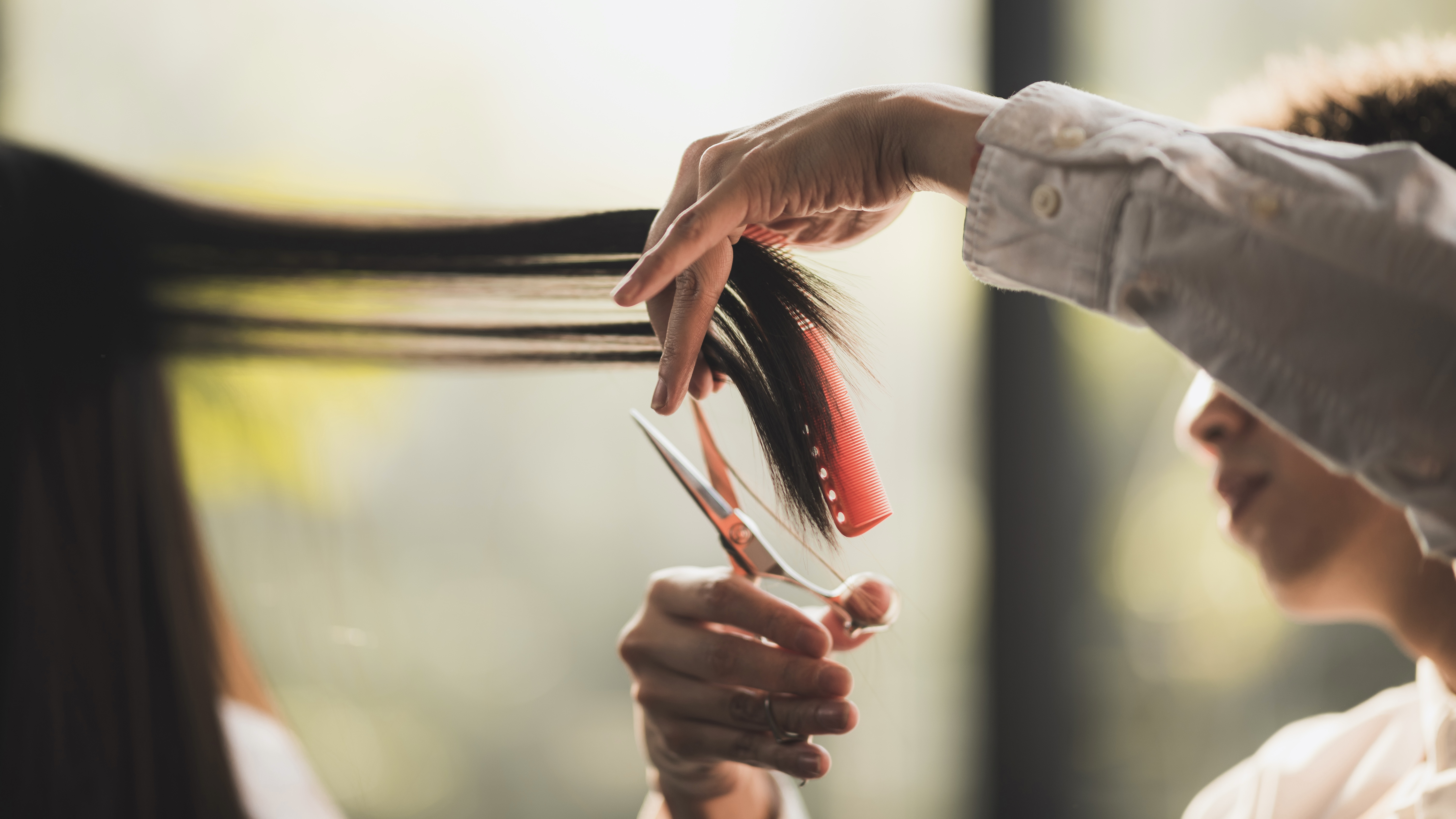 女性をカットする美容師